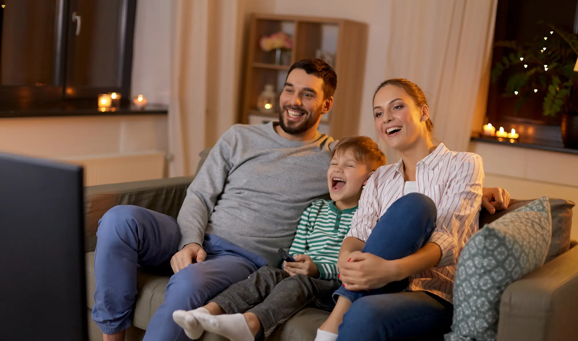 A family watches TV and laughs