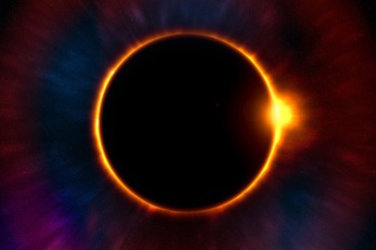 Eclipse. The dark moon covers the sun leaving only visible a ring of fire.