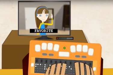 Cartoons. Subtitle on a tv screen: "Favorite."  A Braille display in front of the TV.