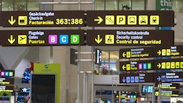 Airport signs with several icons and arrows pointing to different directions