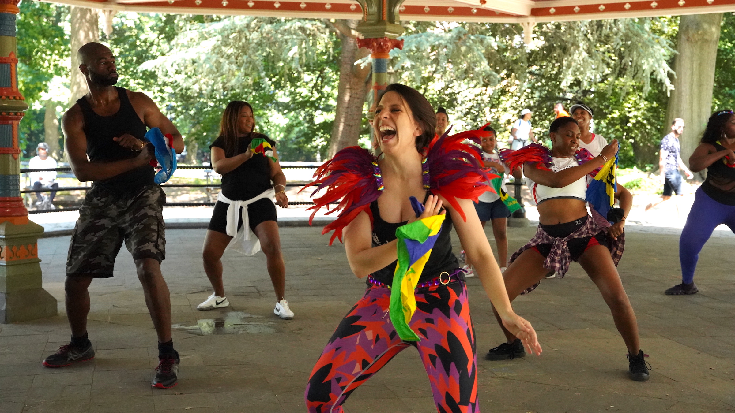 Mickela Mallozi dances in colorful outfits with several members of the Soka Tribe.