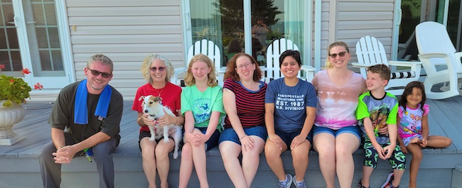 Corinne's family, and her dog, smiling for a group picture