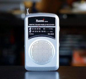 Small rectangular and silver battery operated radio.