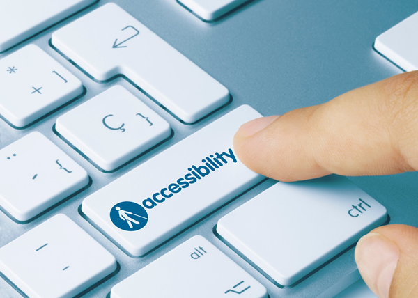 A finger touches a keyboard key labeled Accessibility